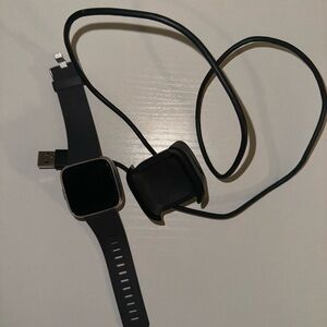 Black Fitbit with grey strap. Charger included. In very good condition!